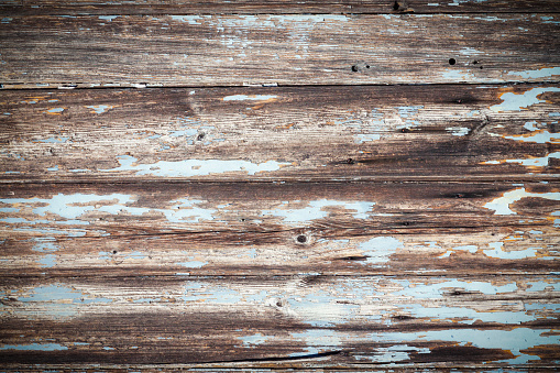 Closeup weathered wooden fence background, full frame horizontal composition with copy space and vignette