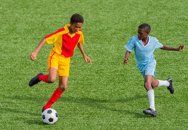 Young boys playing soccer, elevated view.