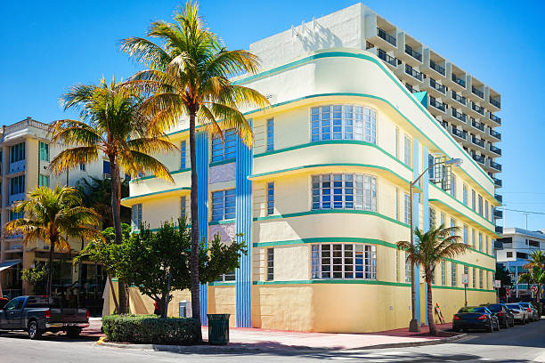 This is a photograph of an Art Deco building exterior at sunset in South Beach, Miami, Florida.