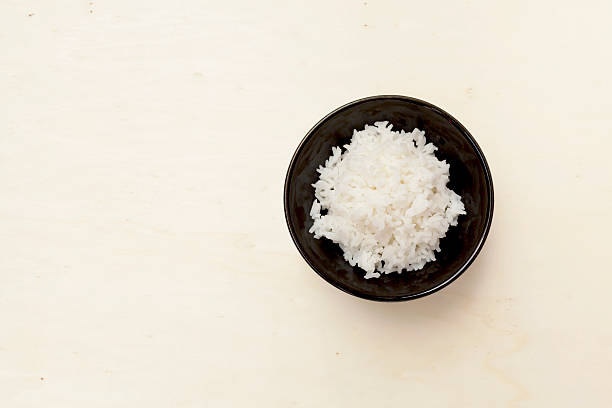 istock Rice in black bowl on wood background 478261562