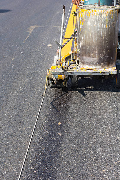 istock Machine eject and worker on road and traffic sign painting 478261708