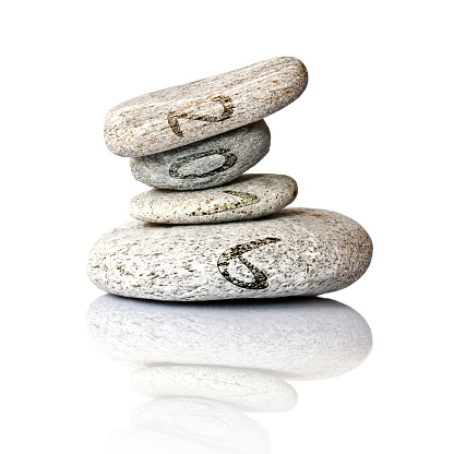 2016 written on stack of pebbles isolated on white background