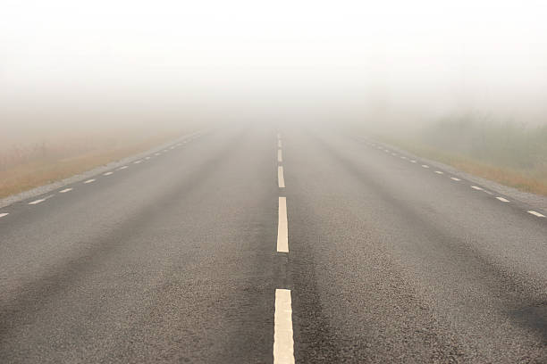 istock asphalt road in heavy fog 478264005