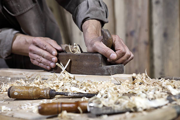 istock hands of carpenter plane on the workbench in carpentry 478265860