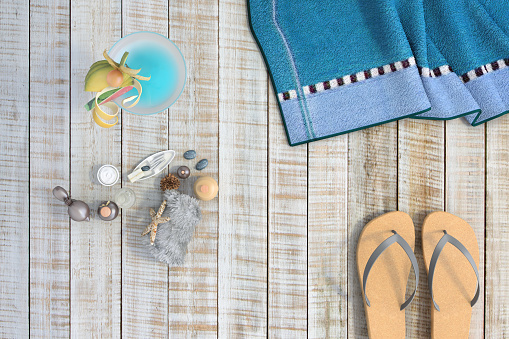 This is a closeup scene, wooden decking covered with beach and summer accessories
