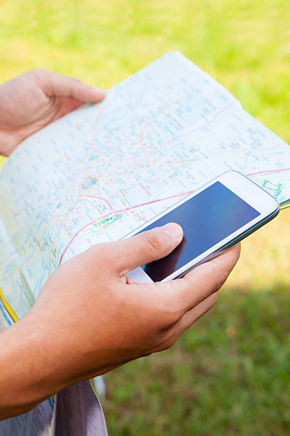 istock Man hand looking direction with maps and mobile phone 478266728