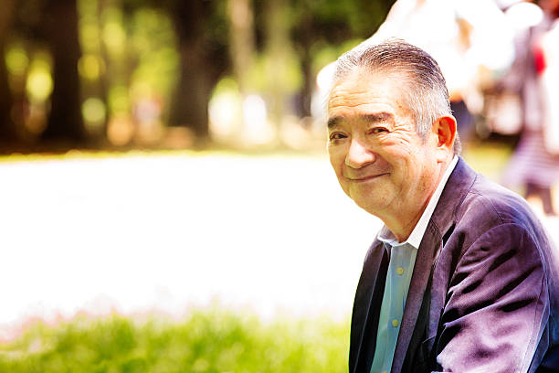 istock Happy handsome Japanese senior man smiling in park 478266852
