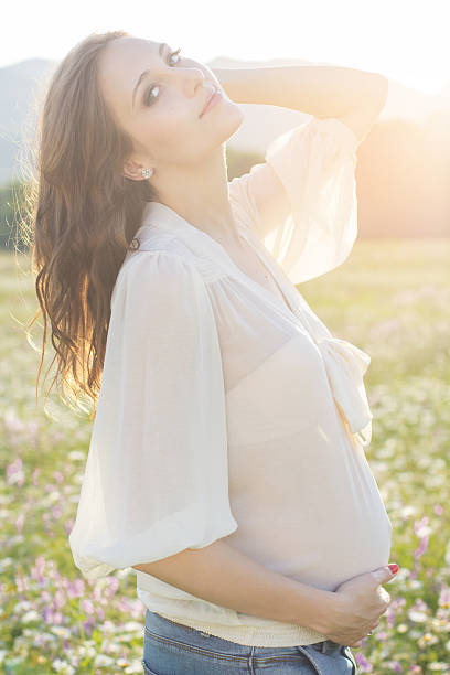 istock Pregnant woman in sunset lights 478267032