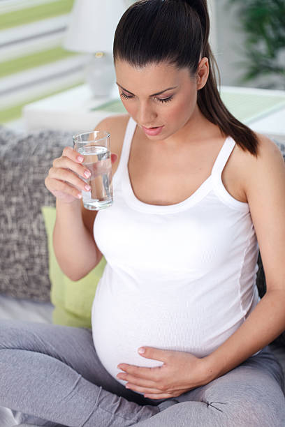istock Pregnant woman drinking water 478267871