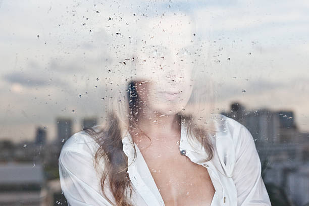 Reflection of the girl in the window stock photo