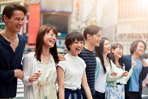 Group of happy young japanese people fun outdoors, Tokyo. Young people walking in Shibuya. All people in the image are worn with casual clothes. Concept for urban lifestyle and friendship. Image is taken during Tokyo Istockalypse 2015
