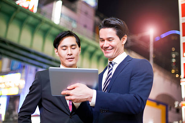 istock Two Japanese businessmen in Tokyo with digital tablet 478272714