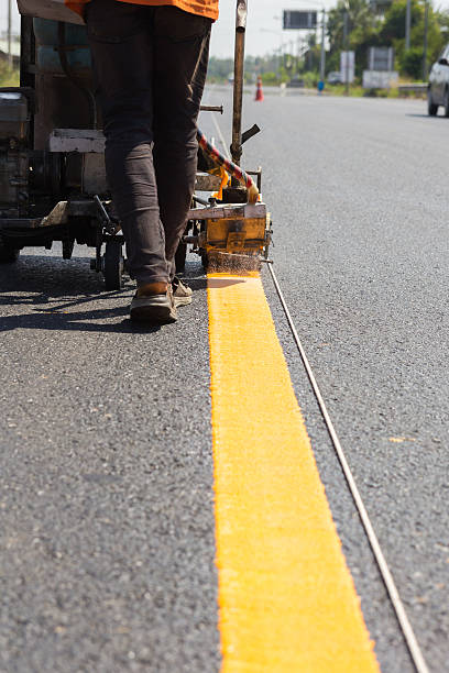 istock Machine eject and worker on road and traffic sign painting 478273476