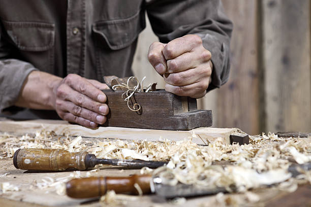 istock hands of carpenter plane on the workbench in carpentry 478273566