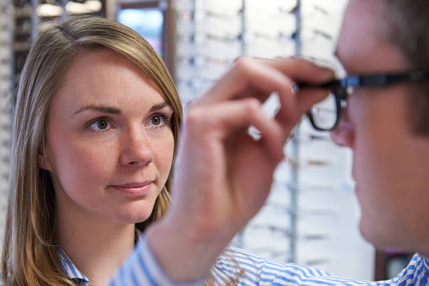 istock Optician Advising Client On Choice Of Glasses 478273710