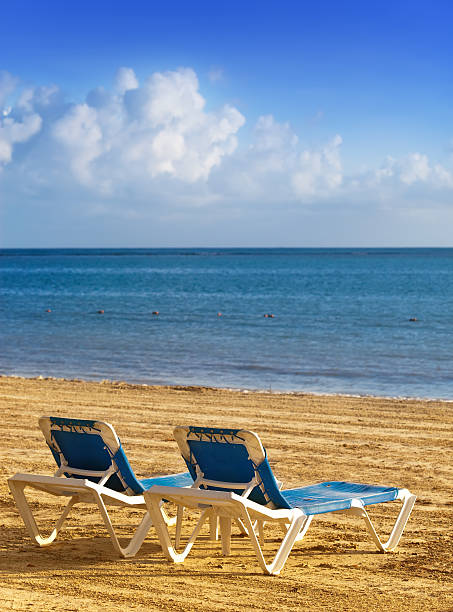 istock chaise lounges on a beach. 478277344