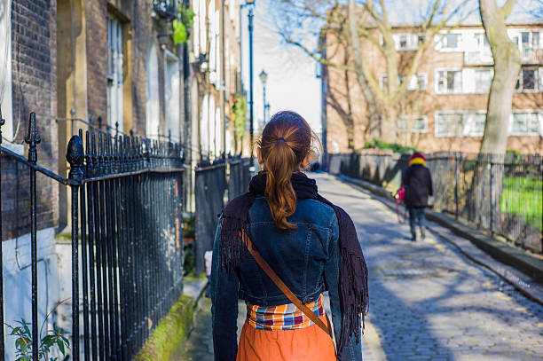 istock Woman walking cobbled street 478278378
