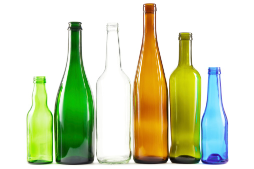 Glass bottles of mixed colors including green, clear white, brown and blue.