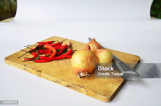 Chili And Onion With Kitchen Tools On White Paper Background Stock Photo - Download Image Now