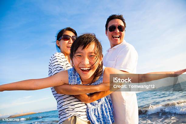 Happy Family Enjoy Summer Vacation On The Beach Stock Photo - Download Image Now - 2015, Adult, Asian and Indian Ethnicities