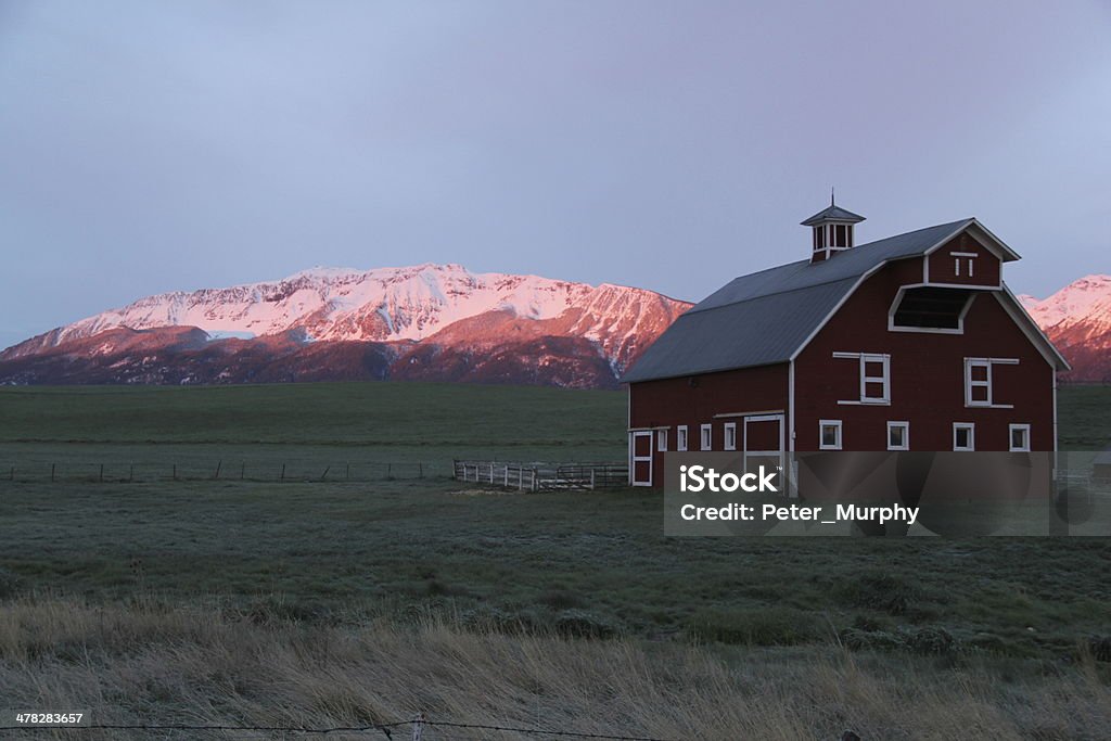 Wallowa Barn At Sunrise Early morning light reveals purple mountain majesty in eastern Oregon. Oregon - US State Stock Photo