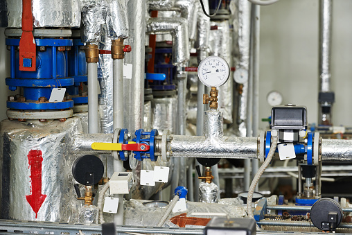 manometers, pipes and faucet valves of gas heating or water circulation system in a boiler room