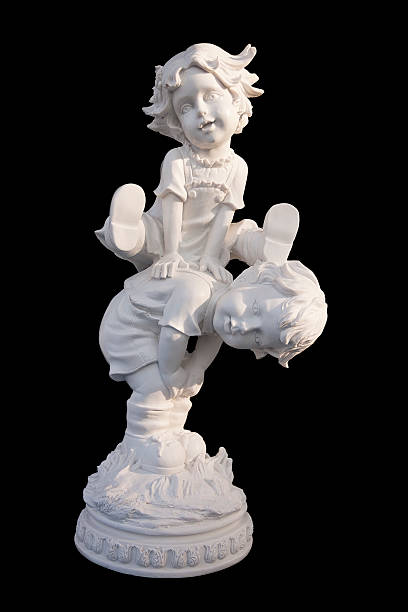 Clay or Ceramic sculpture of brother and sister playing, on white background.