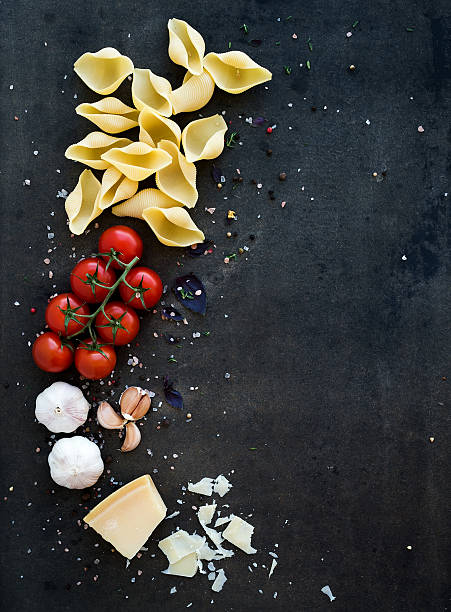 istock Food frame. Pasta ingredients. Cherry-tomatoes, pasta, garlic, basil, parmesan 478287724