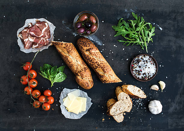 istock Ingredients for sandwich with smoked meat, baguette, basil, arugula, olives 478287750