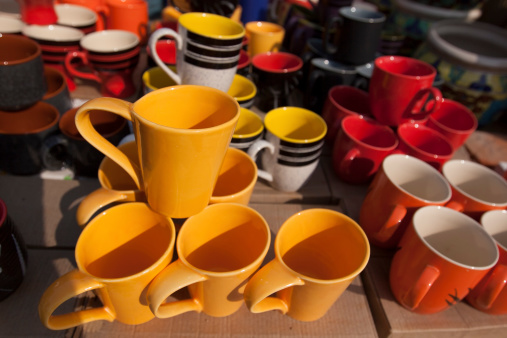 Colorful Ceramic pottery, coffee Mugs and cups for sale in a shop in the market.