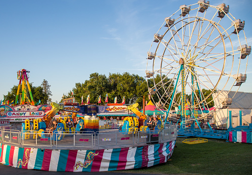 Anderson, California, USA- June 17, 2015:  The rides the Energy Storm and Ferris Wheel are filled with fair goers enjoying the thrills at the Shasta County Fair.