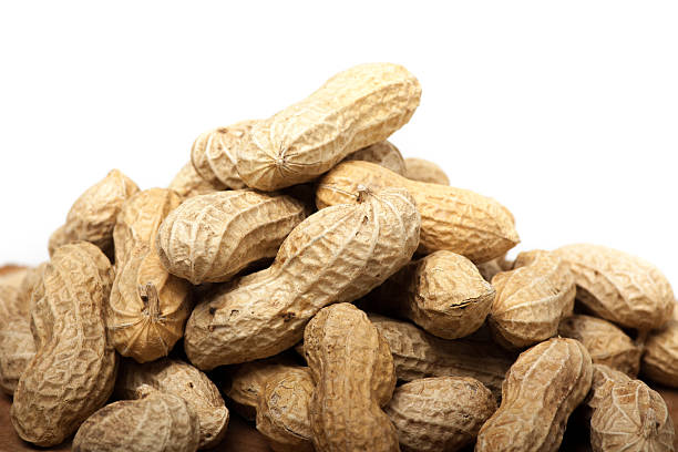 istock Pile of unshelled peanuts, isolated on white background 478289940