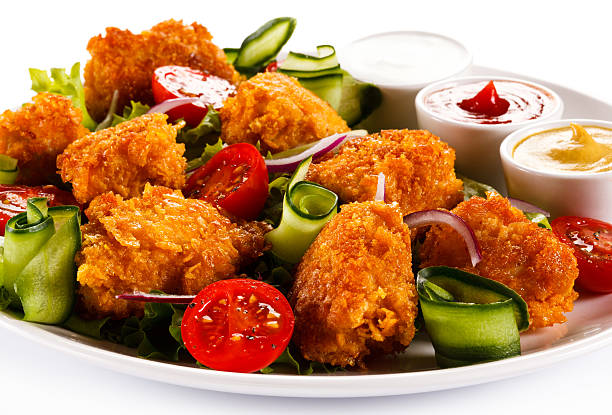 istock Chicken nuggets and vegetables on white background 478290190