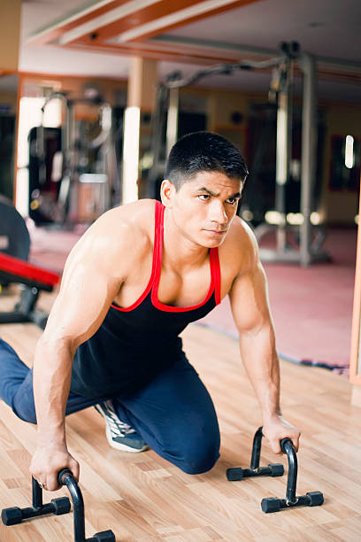 istock Young muscular man doing push-ups in a gym 478290432