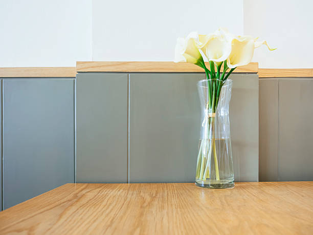 istock White Calla Lily flowers in glass vase on Table 478291412