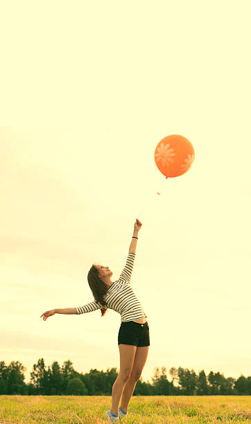 istock Happy woman with balloons 478292776