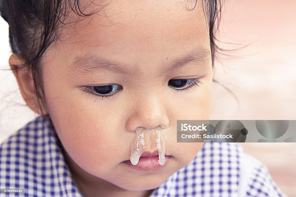 little girl with snot flowing from her nose Baby - Human Age Stock Photo