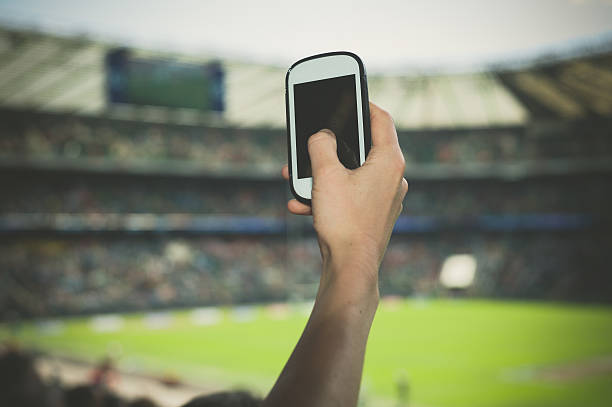istock Hand filming sports event on phone 478295486