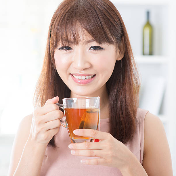 istock Asian girl enjoying tea 478295758