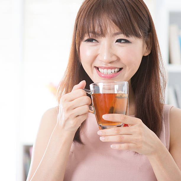 istock Asian girl drinking tea 478295760