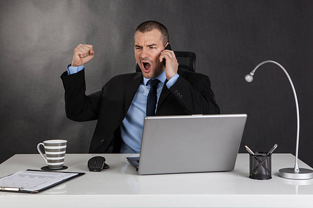 istock Victorious businessman in office 478298096