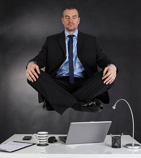 istock Businessman meditating in the office 478300872