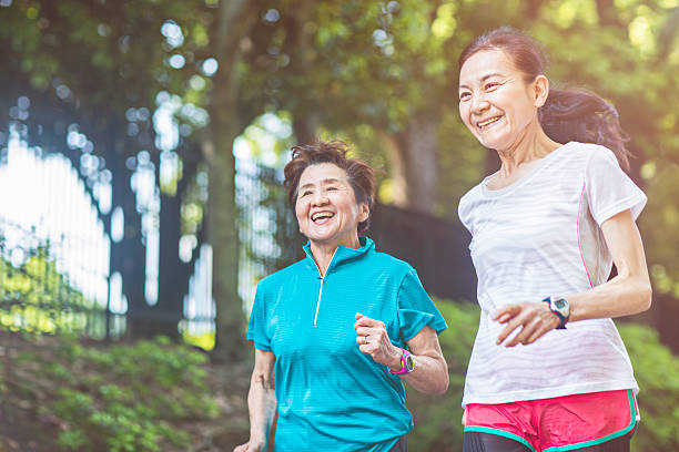 senior donna corre nel parco di yoyogi - running jogging asian ethnicity women foto e immagini stock