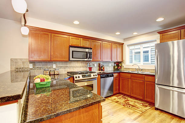 istock Maple kitchen cabinets with steel appliances and granite tops 478301664