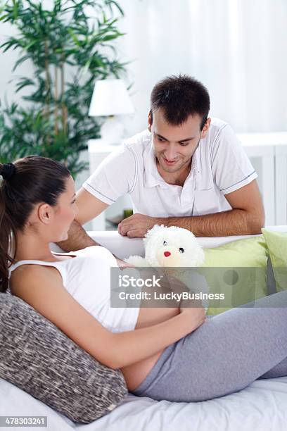 Pregnant Woman With Her Husband Stock Photo - Download Image Now - Abdomen, Adult, Affectionate