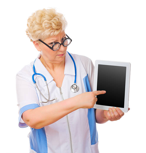 istock Mature funny doctor with tablet PC 478303715