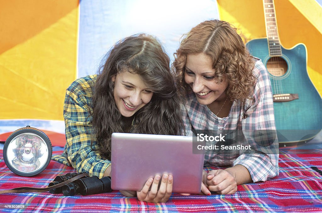 Кемпинг: Друзья Смотреть планшет в палатка - Стоковые фото 20-29 лет роялти-фри