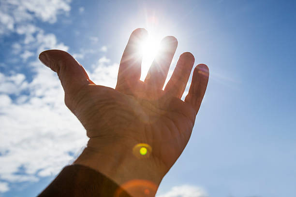 istock Hand to sun,sun rays passing through fingers 478305108