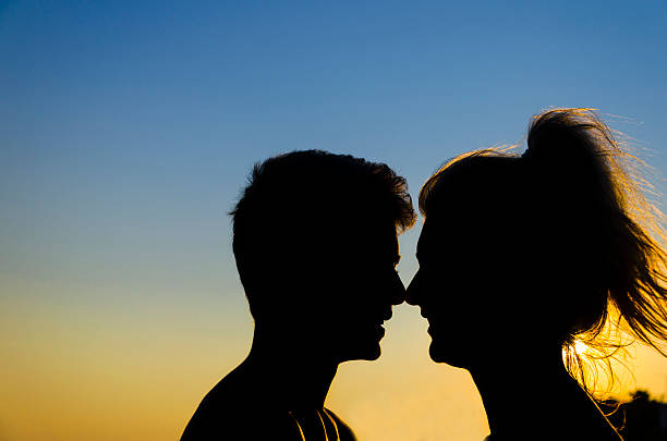 istock romantic couple silhouette profiles at sunset 478305135