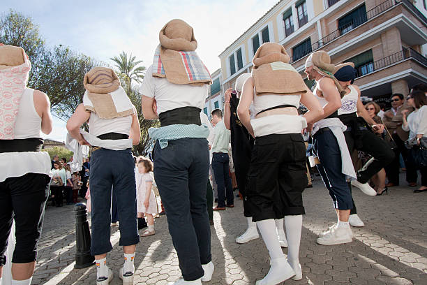 "Costaleros" waiting for their parade float in Holy Week. Carmona, Spain- mars 29, 2015: Rear view of group of "Costaleros" preparing to carry and waiting for their parade float in a Holy Week procession in Carmona, Sevilla province, Andalucía, Spain. carmona stock pictures, royalty-free photos & images